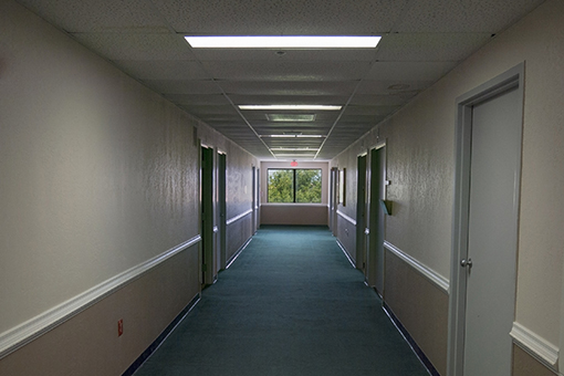 Dull Corridor of a Commercial Property in Tampa FL In Need of Interior Painting Service