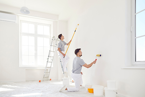 Two House Painters Painting Wall of a Property in Tampa FL