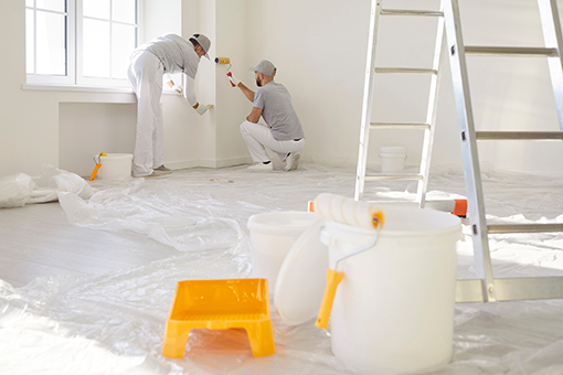Floors Covered While Two Painters Are Painting Walls of a Gandy Florida House