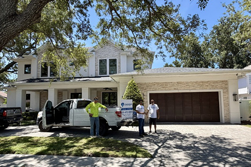 Professional House Painters Standing Beside Their Company Vehicle Parked in Tampa FL